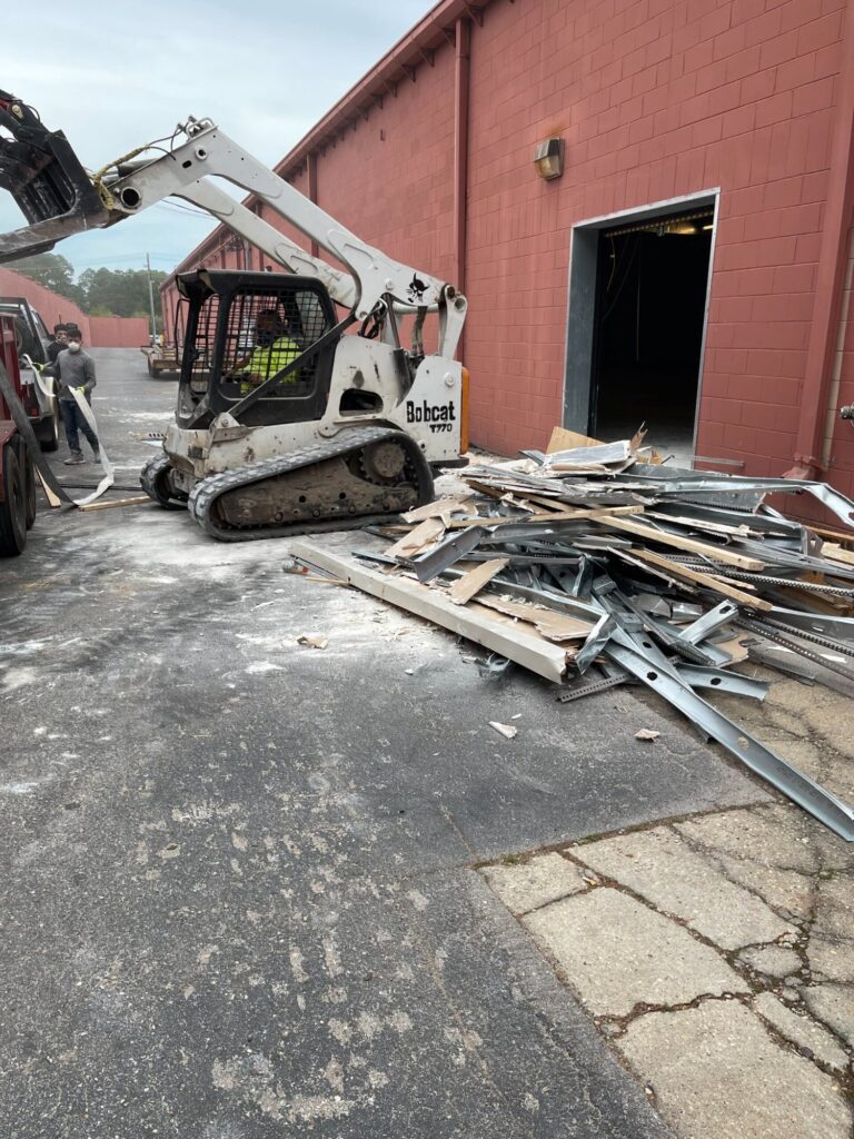 Commercial demolition in Mobile, AL: loading debris outside for haul-off