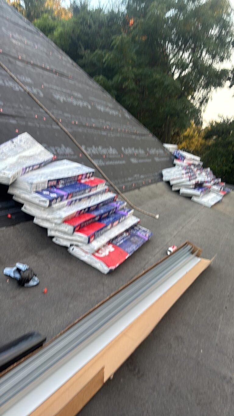 Roof replacement in Mobile, AL: architectural shingles loaded on the roof