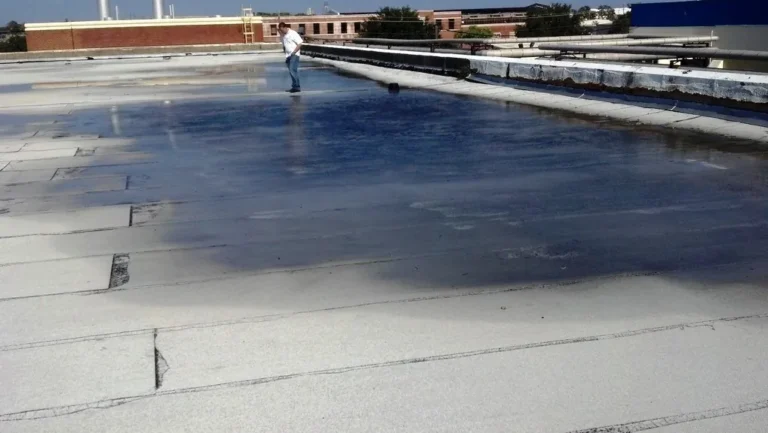 Commercial concrete roof deck with old modified bitumen roof and ponding water before restoration