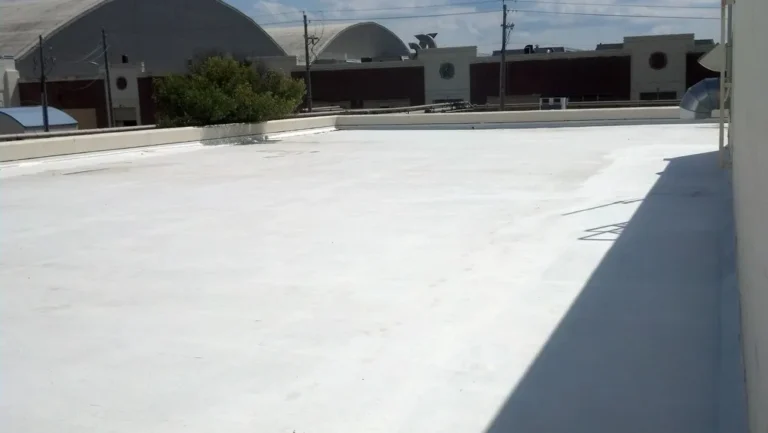 Finished white roof coating on a commercial concrete roof deck