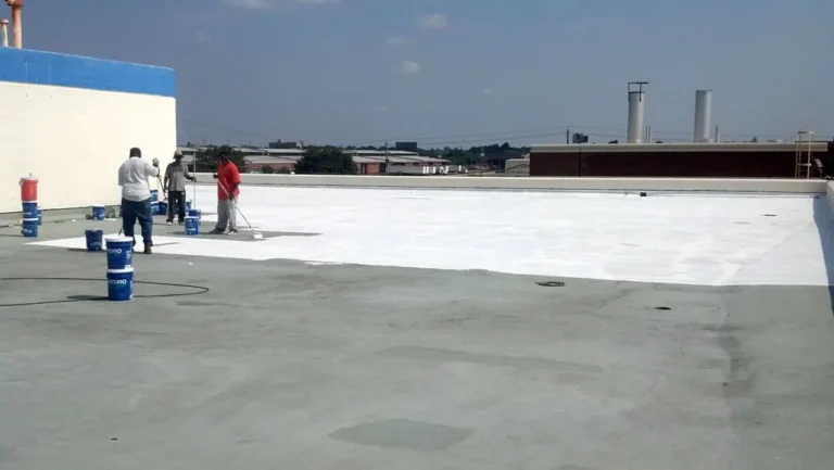 White finish coat being applied over the reinforced base coat