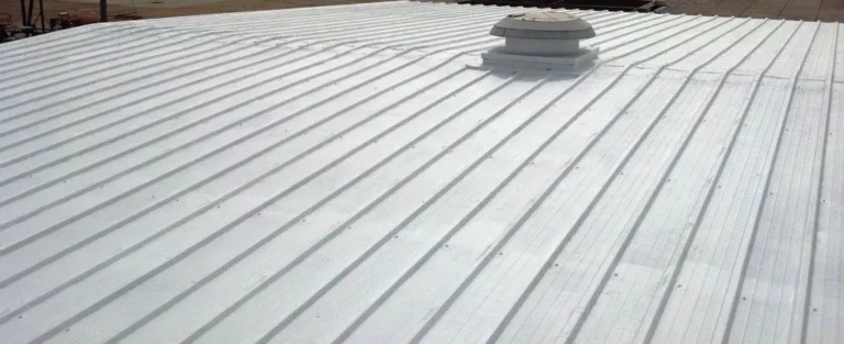 Completed white cool-roof coating on a commercial metal roof