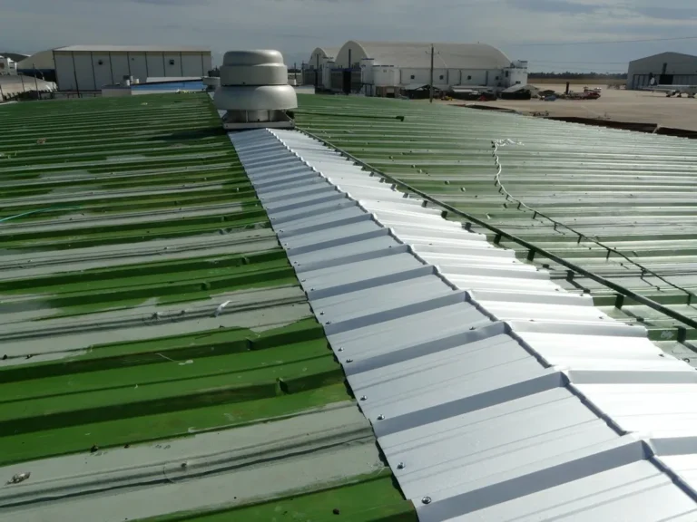 Damaged metal roof panels replaced before coating