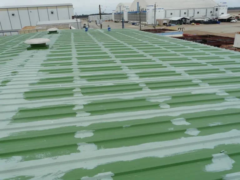 Metal roof seams and fasteners sealed with base coat and reinforcing fabric